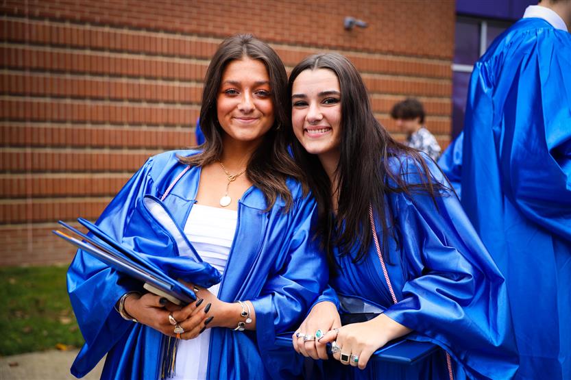 A group of graduates wearing blue robes